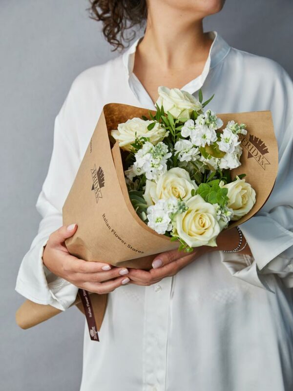 Girl holding Bouquet Pure bouquet with and white roses and white pansy